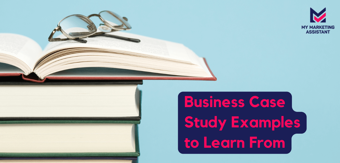 Books in pile on a table with glasses on top behind blue wall