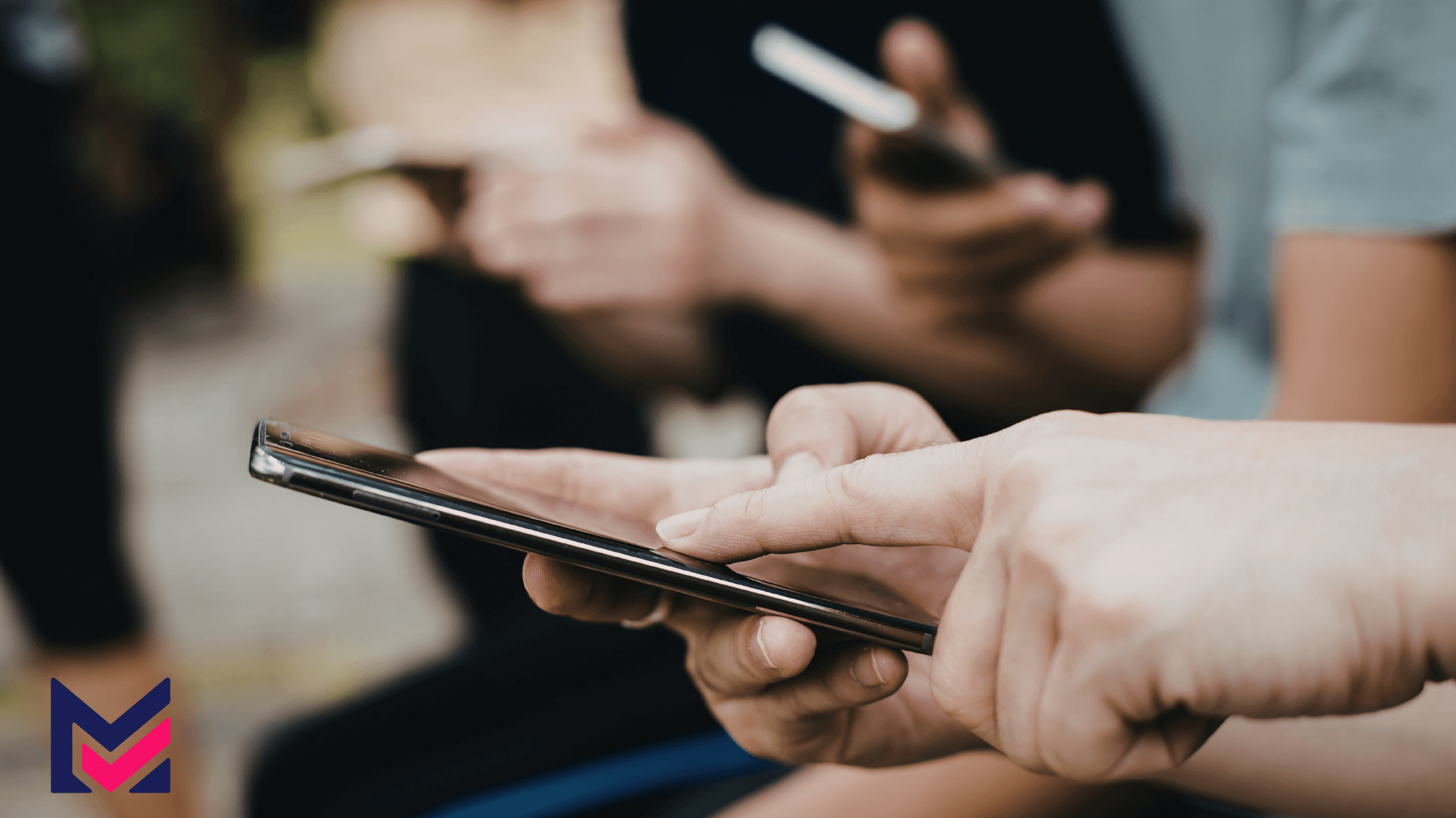 Close-up shot highlighting multiple people with phones.